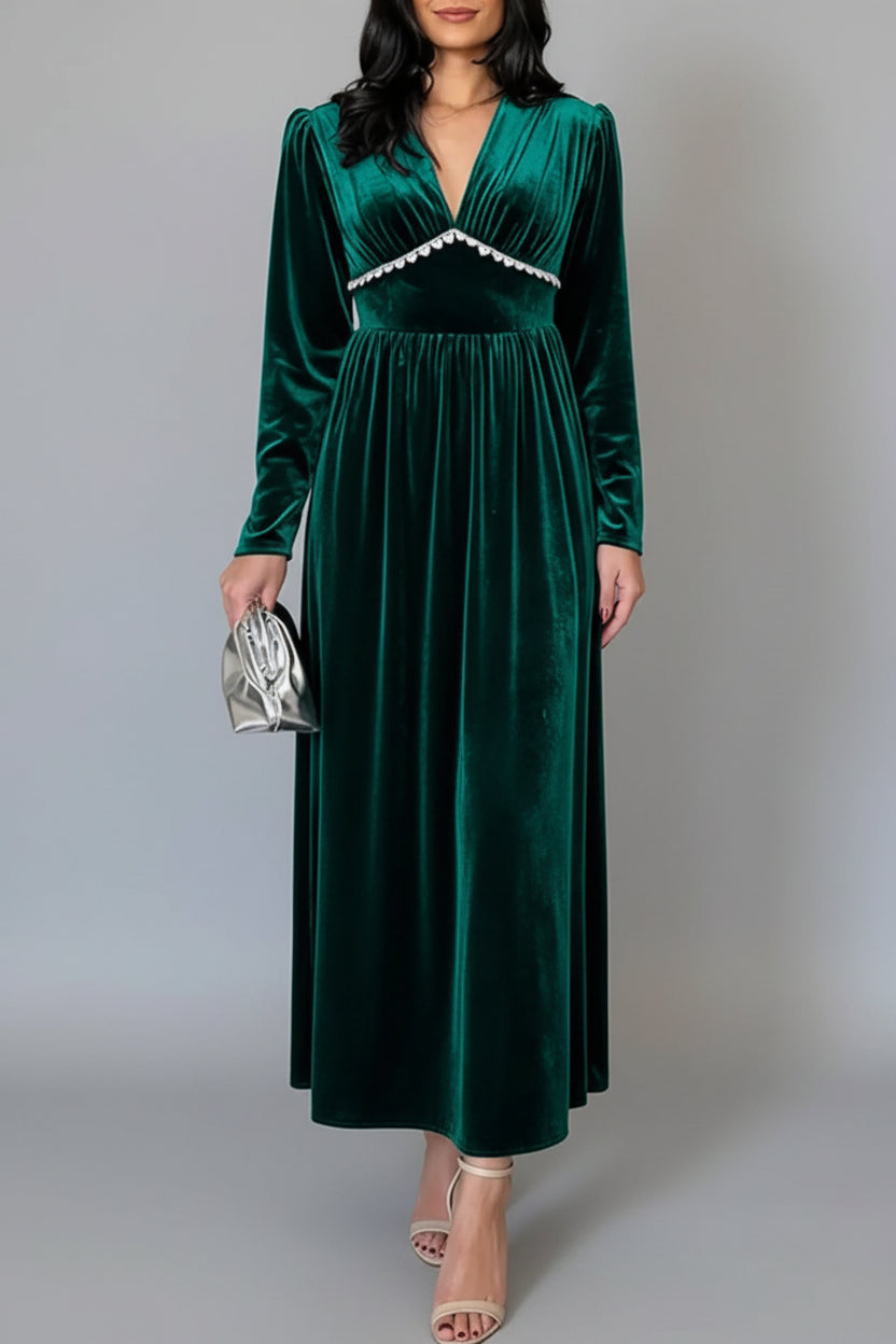 Woman wearing a green velvet dress on a gray background