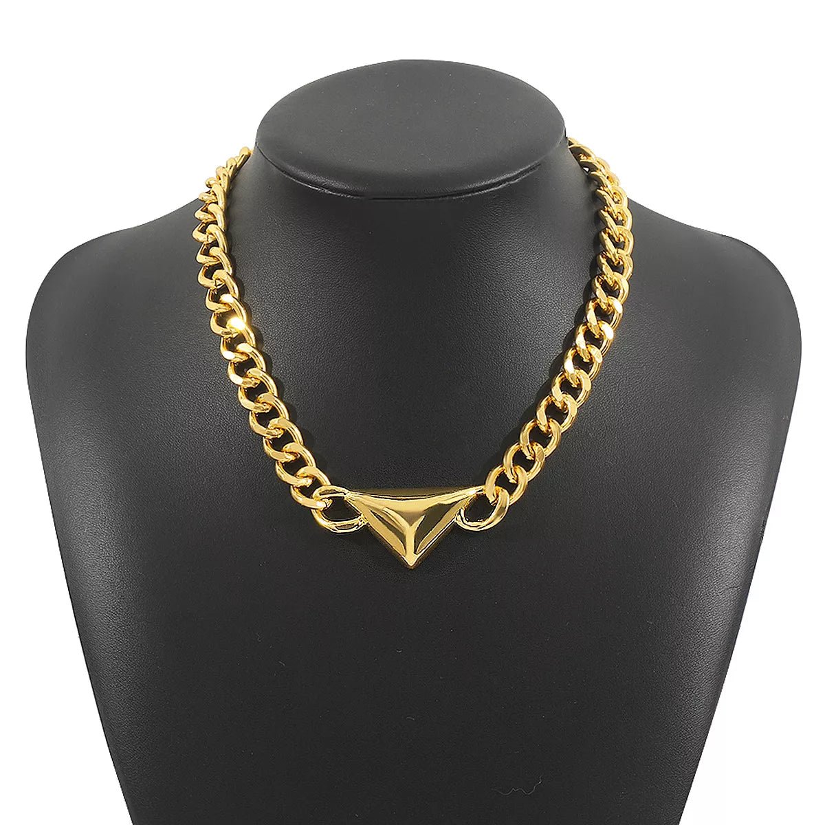 Gold chain necklace on a black mannequin bust