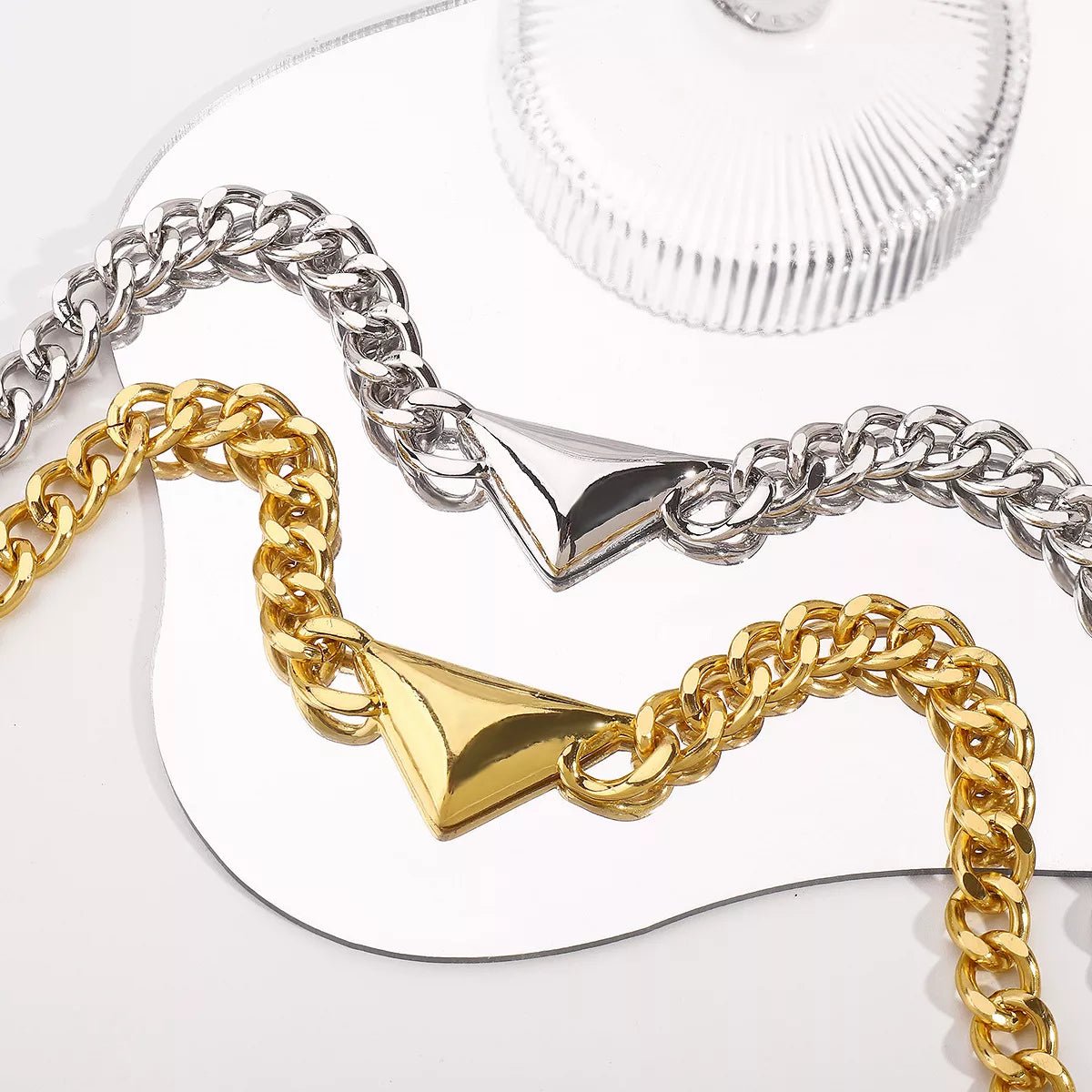 Gold and silver chain necklaces on a white background