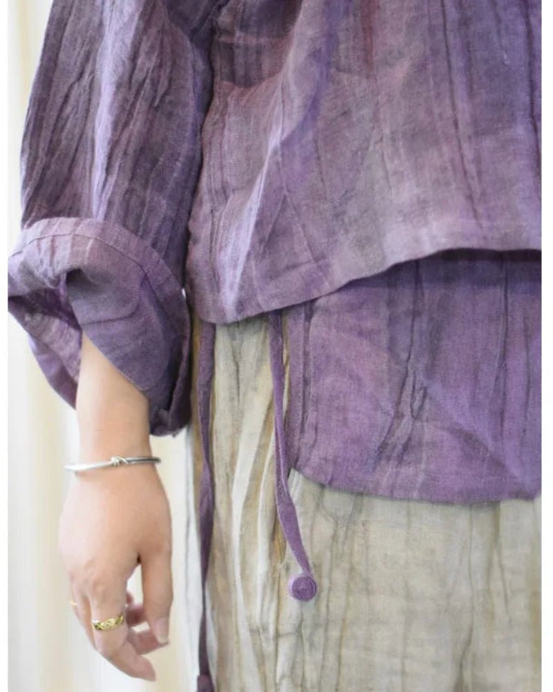 Purple layered garment with a neutral background