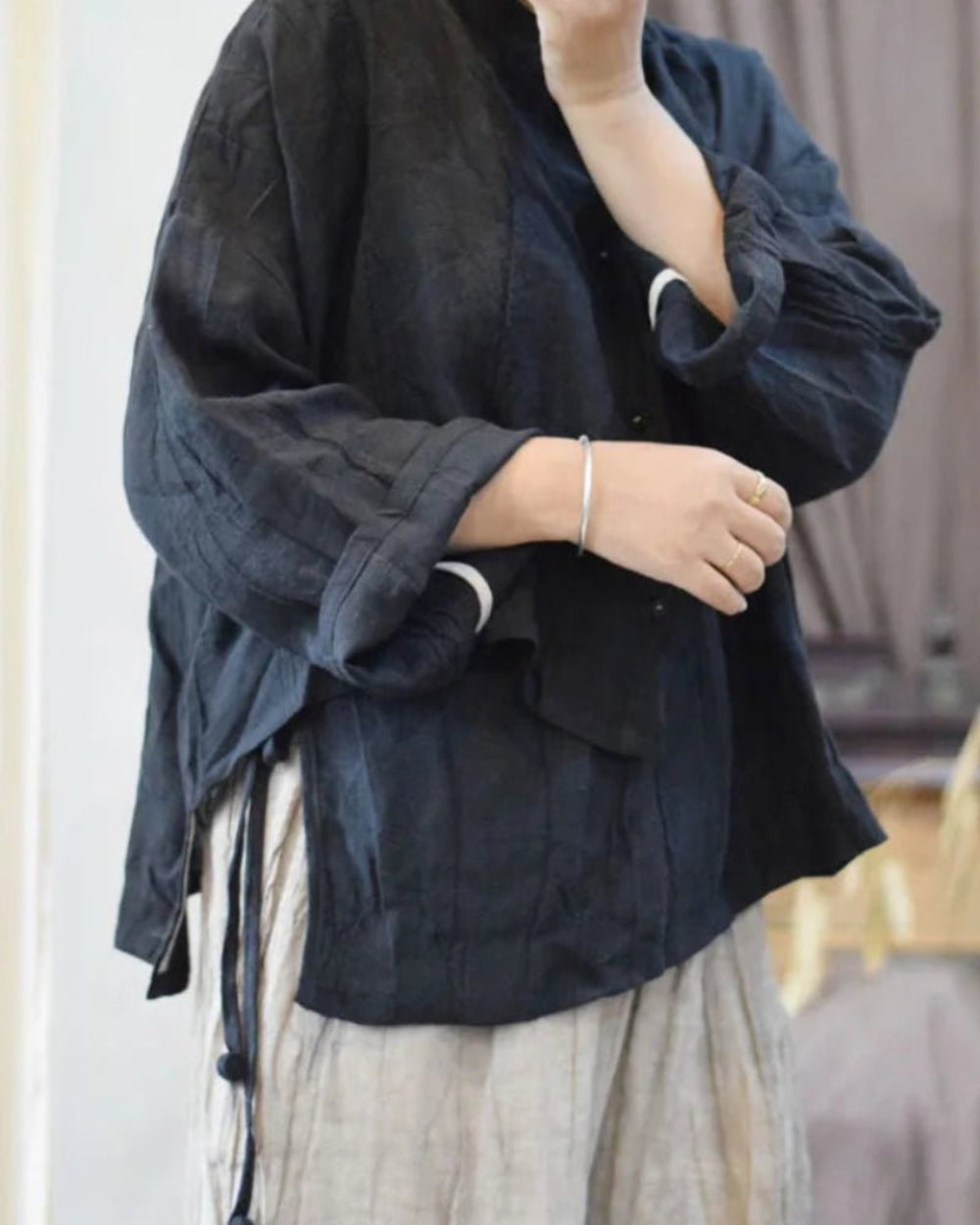 Person wearing a dark blue jacket with a blurred background