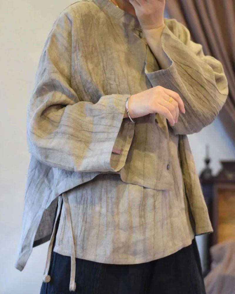 Person wearing a textured beige jacket with a blurred background