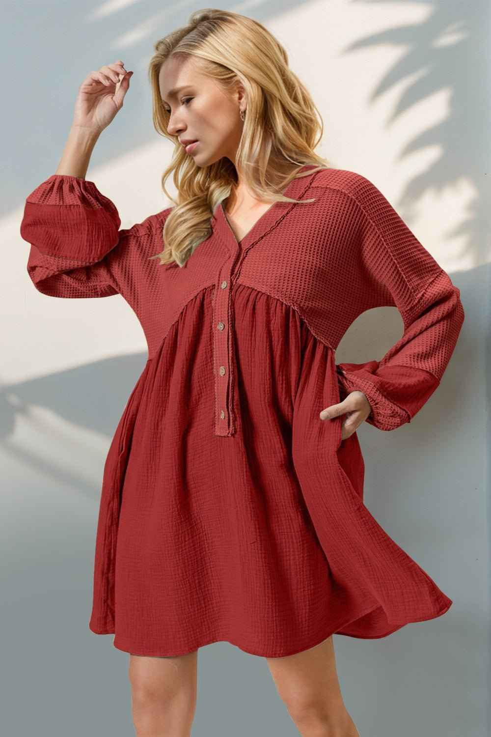 Woman wearing a red dress against a neutral background