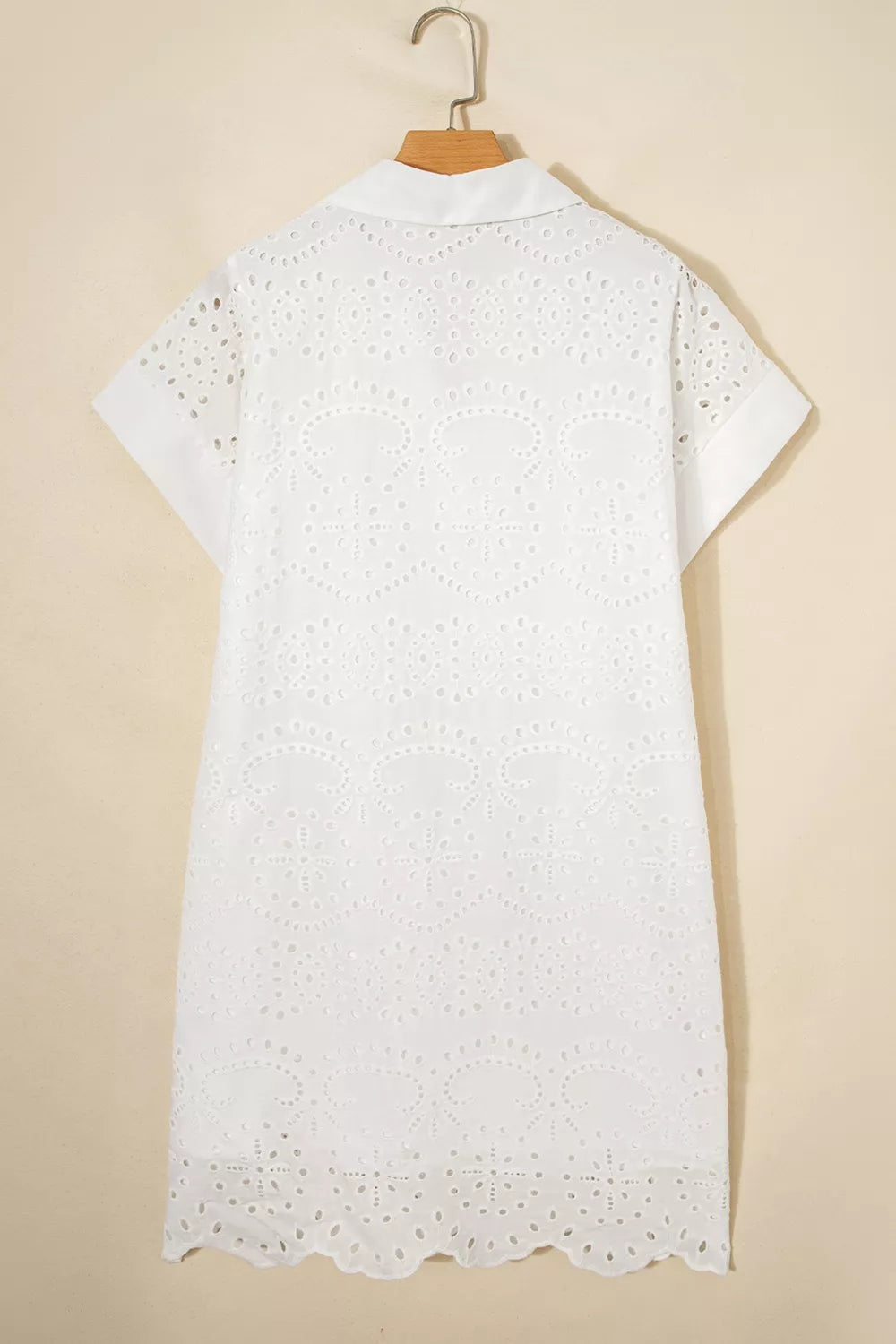 White lace dress on a beige background