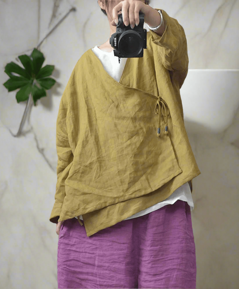 Woman wearing yellow ramie v-neck boho blouse.