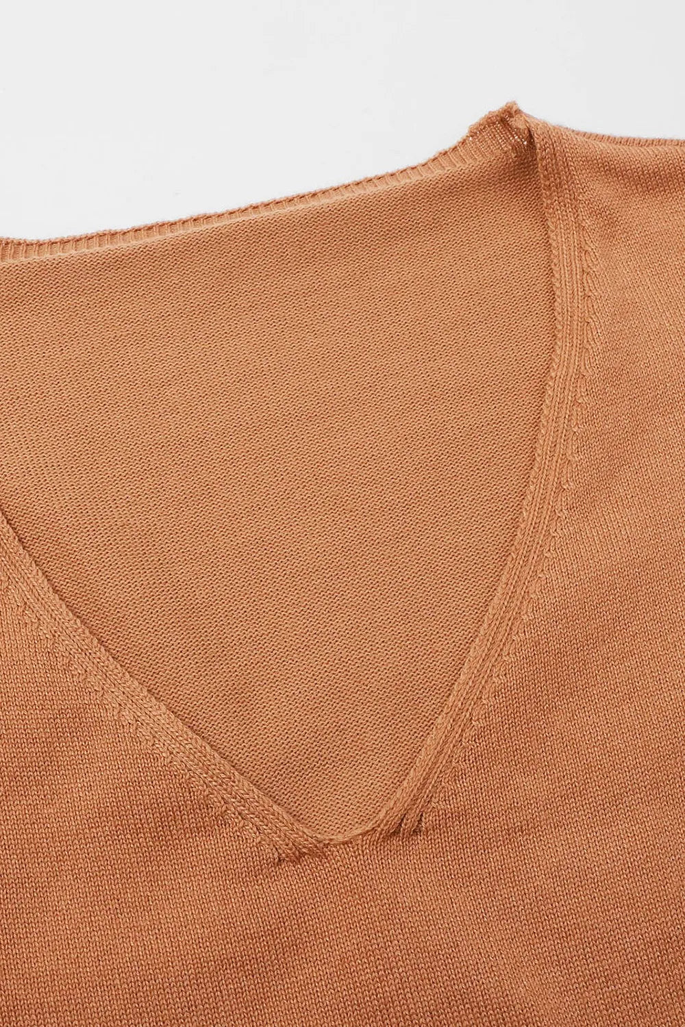 Close-up of a brown fabric with a V-neckline on a white background