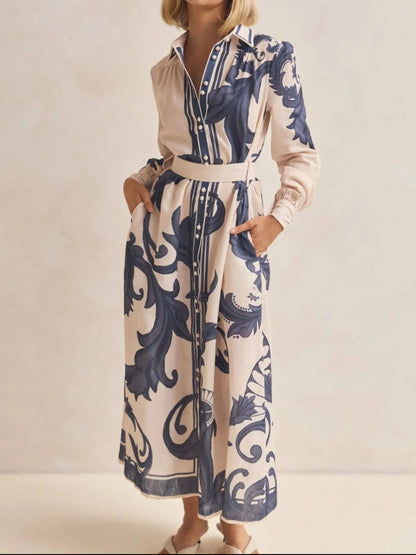 Woman wearing a long floral dress with a neutral background