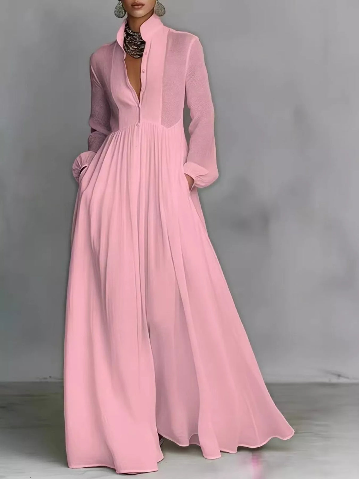 A_model_posing_in_a_vibrant_pink_long-sleeve_button-front_maxi_dress_featuring_a_V-neckline_Victorian-inspired_sleeves_and_a_relaxed_flowy_silhouette.