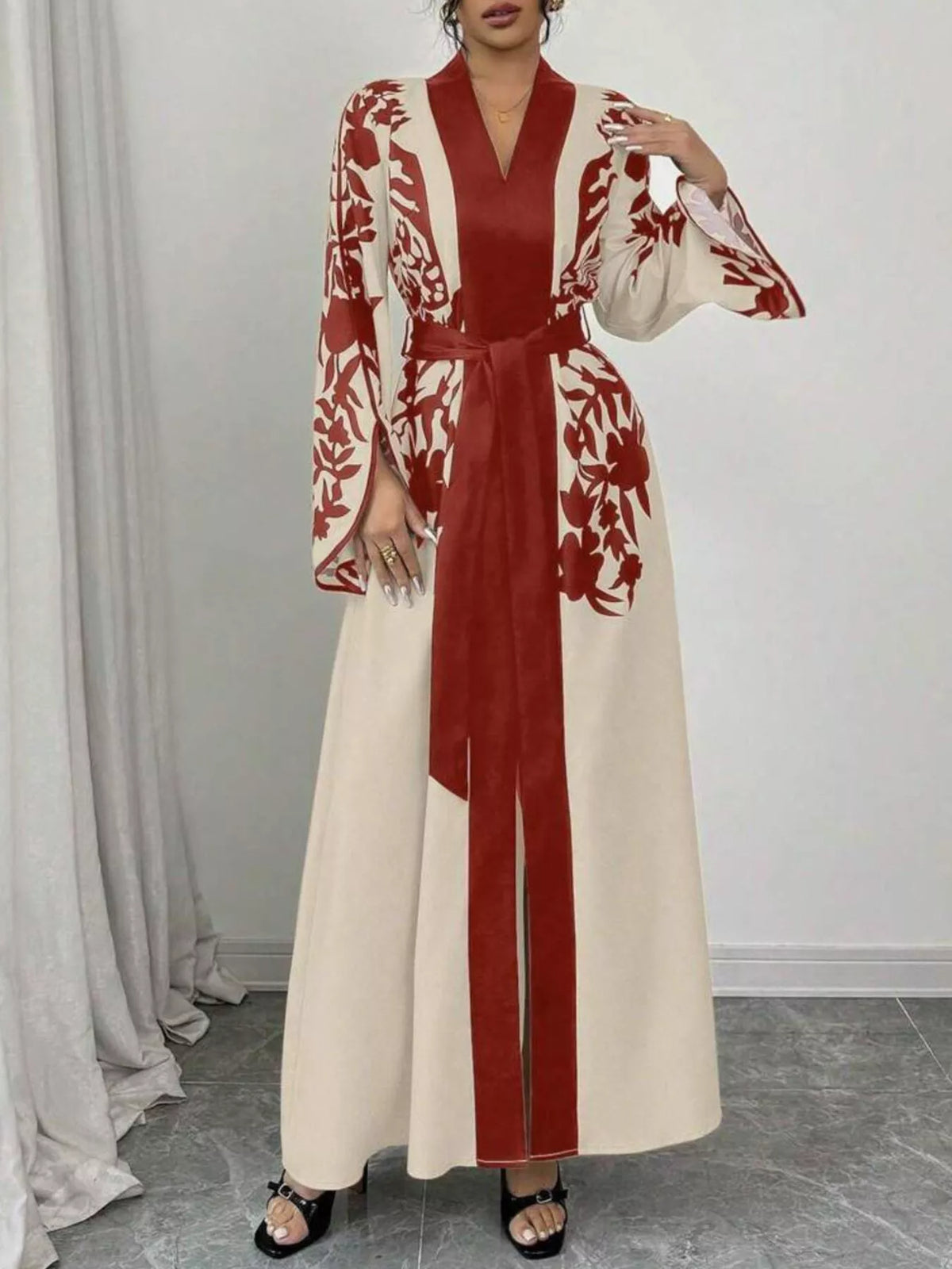 Long dress with red and white floral pattern on a plain background