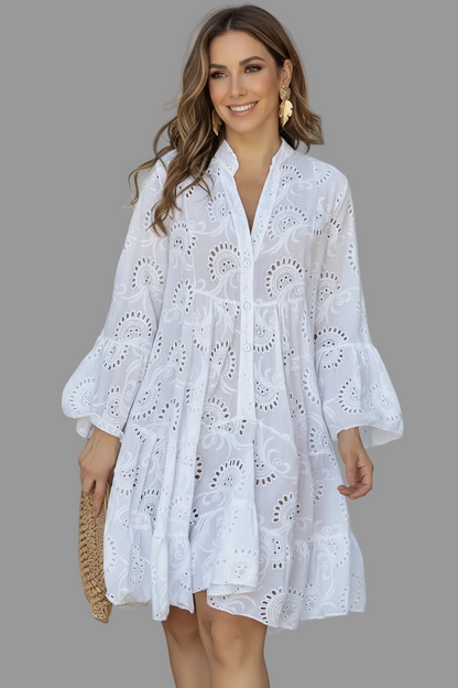 Woman wearing a white lace dress on a gray background