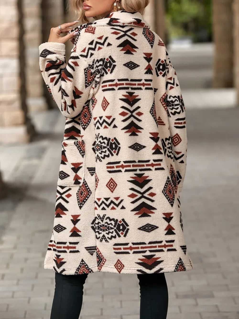 Person wearing a patterned coat on a blurred street background