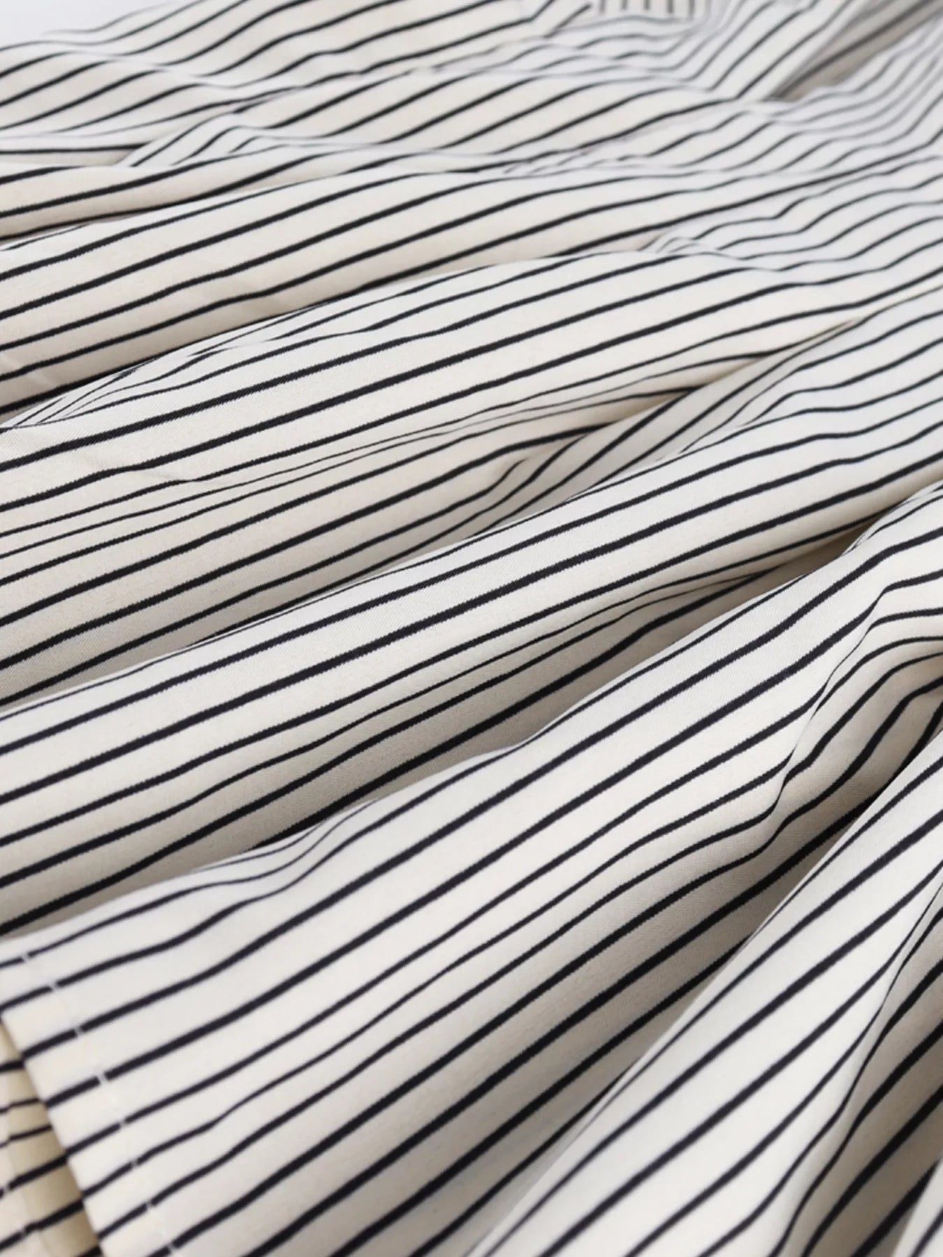 Close-up of striped fabric with black and white lines.