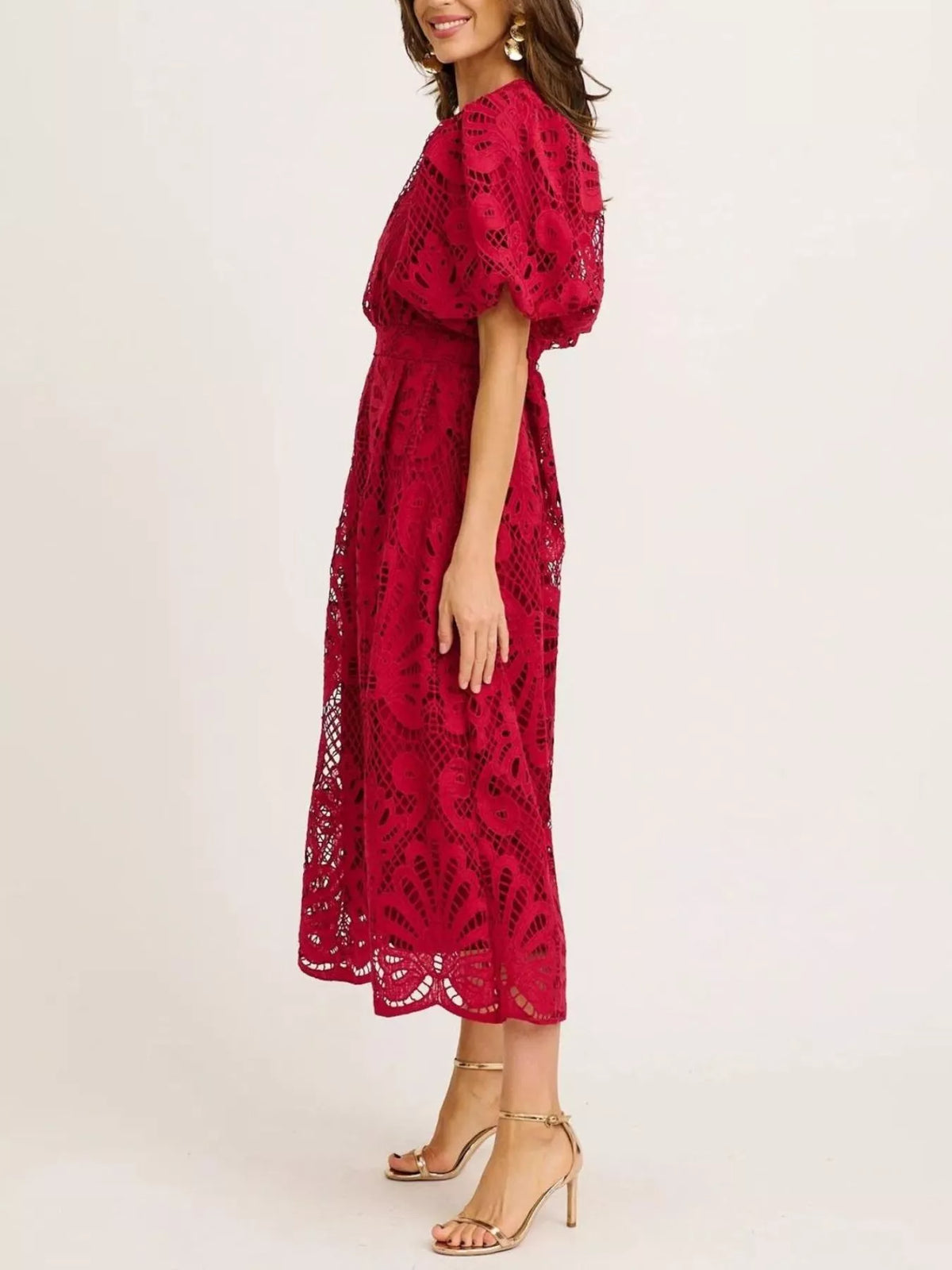 Red lace dress worn by a model on a white background