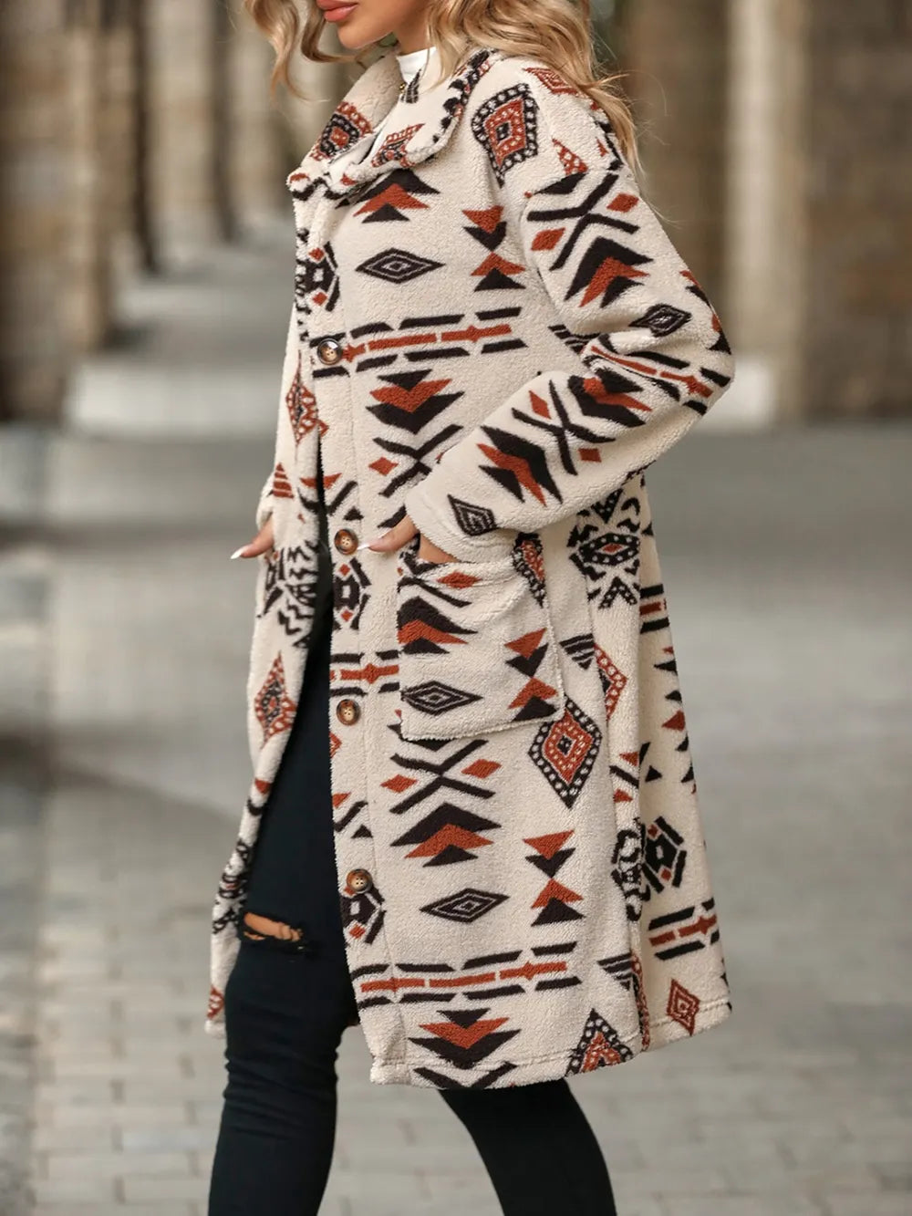 Person wearing a patterned coat with a blurred background
