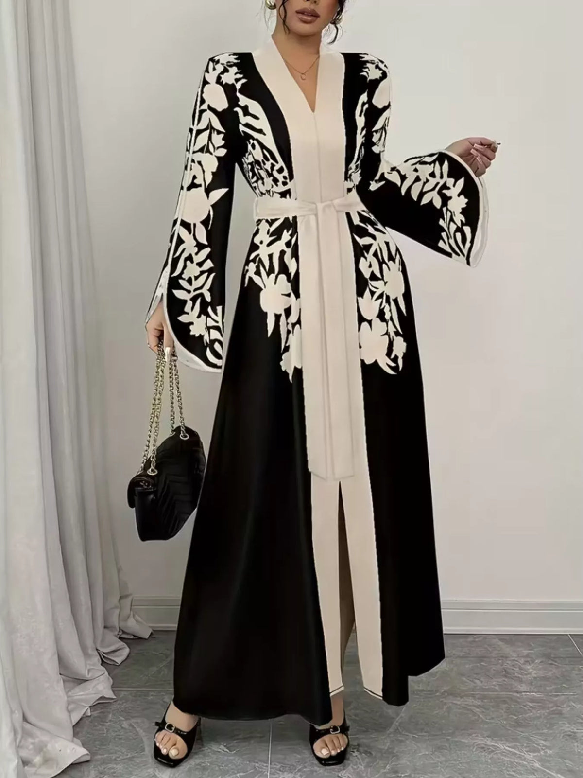 Woman wearing a black and white floral dress with a white background
