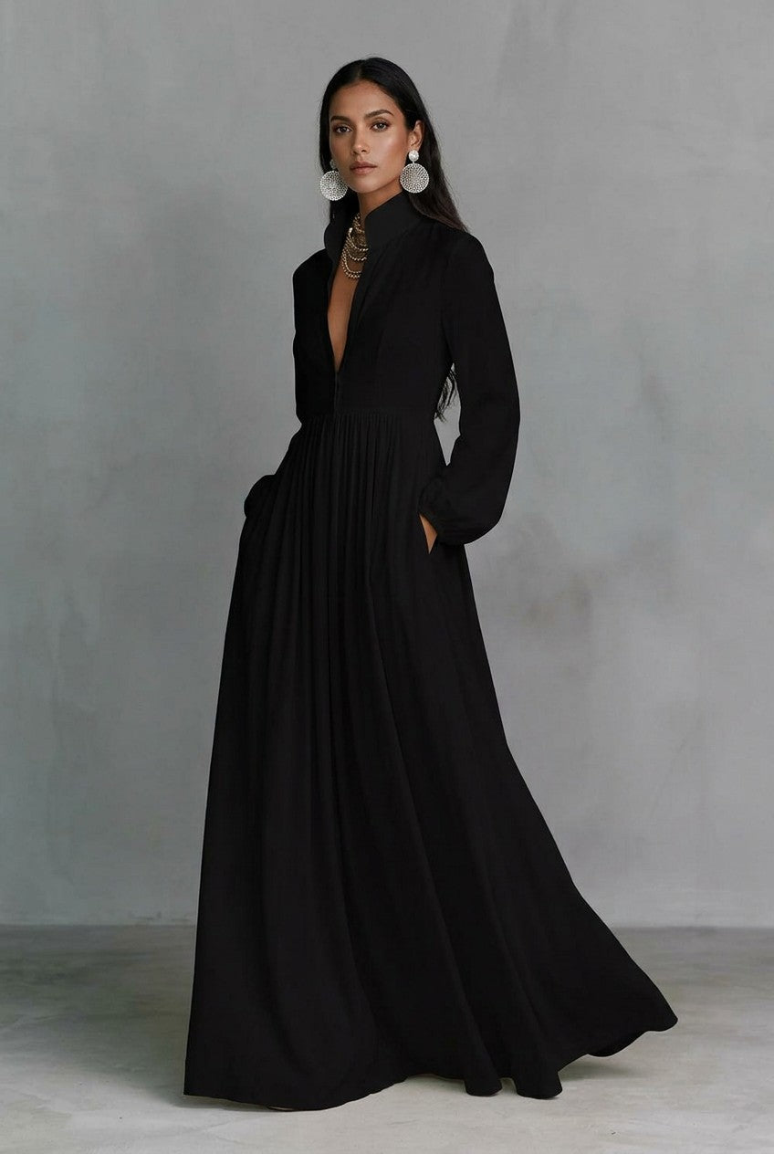 A_model_posing_in_a_black_long-sleeve_button-front_maxi_dress_featuring_a_V-neckline_Victorian-inspired_sleeves_and_a_relaxed_flowy_silhouette.