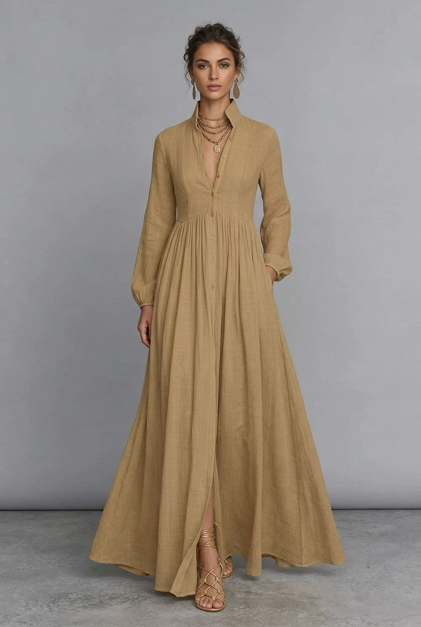 A_model_posing_in_a_khaki_long-sleeve_button-front_maxi_dress_featuring_a_V-neckline_Victorian-inspired_sleeves_and_a_relaxed_flowy_silhouette.