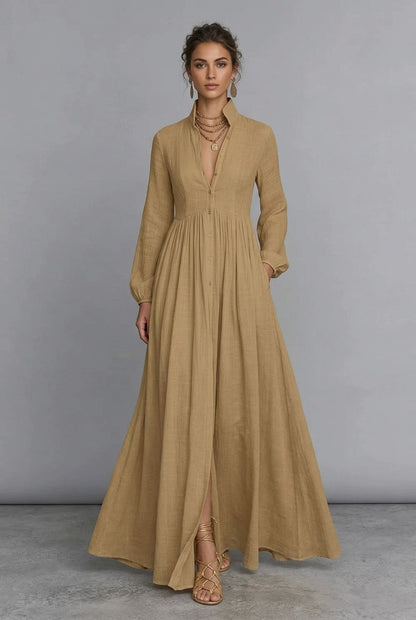 A_model_posing_in_a_khaki_long-sleeve_button-front_maxi_dress_featuring_a_V-neckline_Victorian-inspired_sleeves_and_a_relaxed_flowy_silhouette.