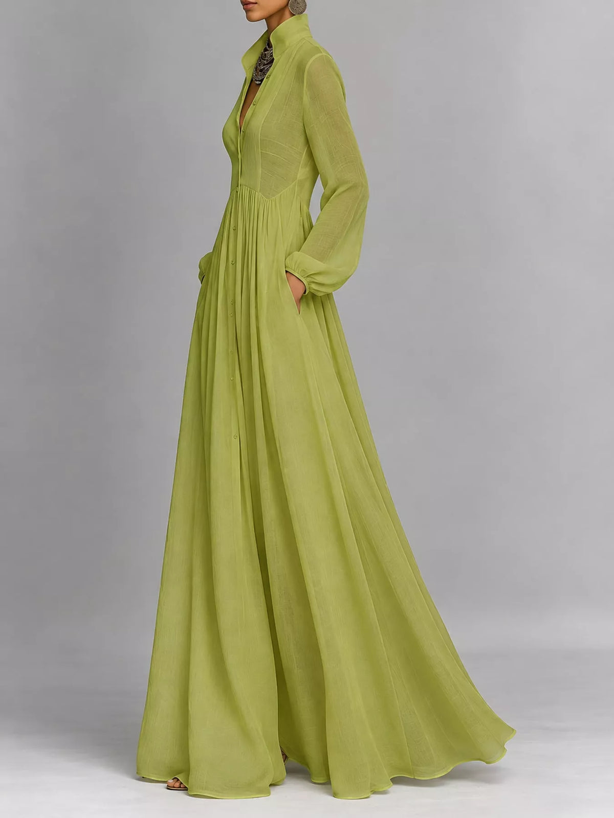 A_model_posing_in_a_sage_green_long-sleeve_button-front_maxi_dress_featuring_a_V-neckline_Victorian-inspired_sleeves_and_a_relaxed_flowy_silhouette.
