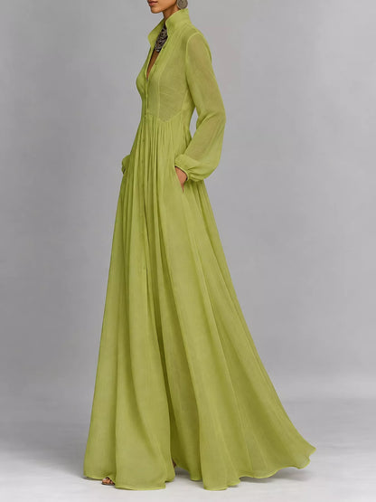 A_model_posing_in_a_sage_green_long-sleeve_button-front_maxi_dress_featuring_a_V-neckline_Victorian-inspired_sleeves_and_a_relaxed_flowy_silhouette.