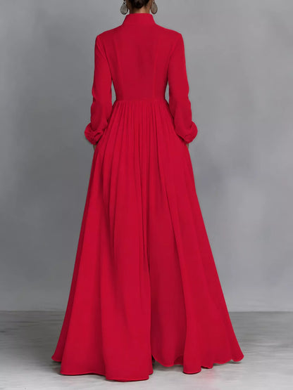 A_model_posing_in_a_vibrant_red_long-sleeve_button-front_maxi_dress_featuring_a_V-neckline_Victorian-inspired_sleeves_and_a_relaxed_flowy_silhouette