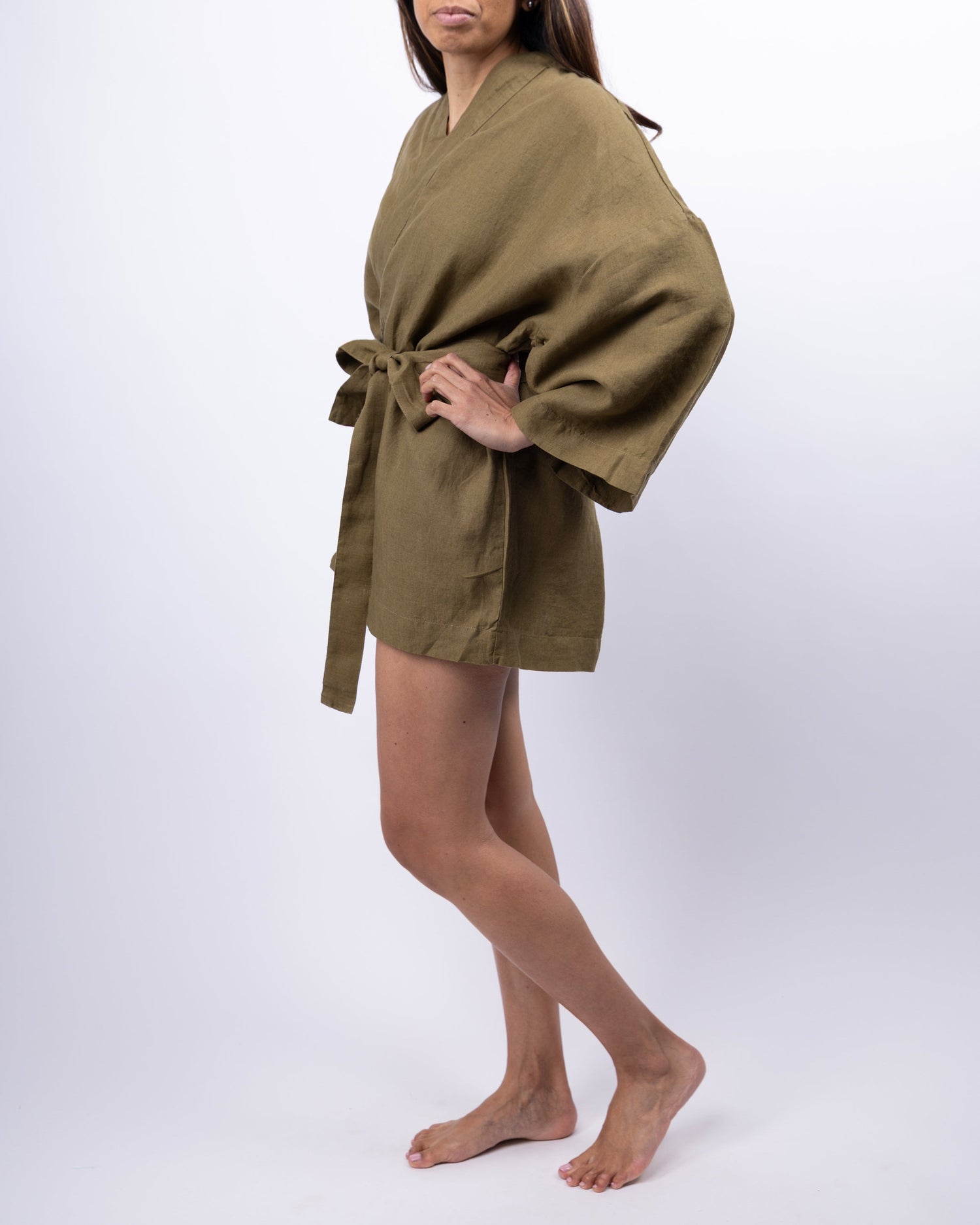 Person wearing a green robe on a white background