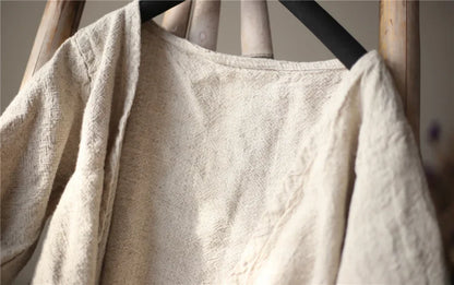 Beige towel draped over a wooden rack