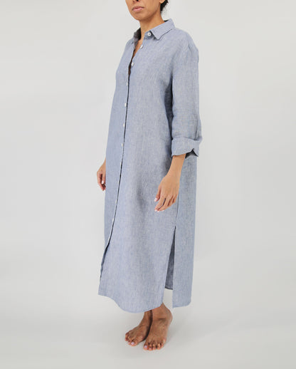 Person wearing a long blue striped shirt dress on a white background
