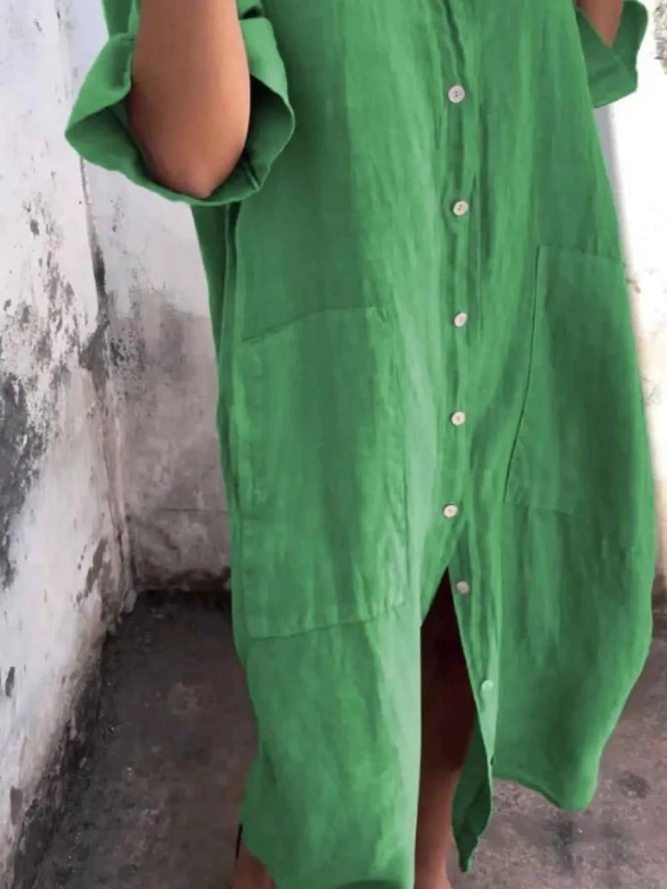Green dress worn by a person against a plain background