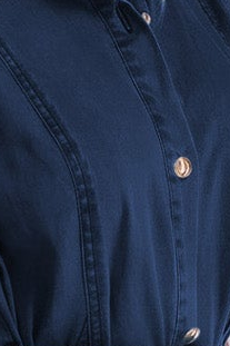 Close-up of a dark navy blue button-up shirt showing the fabric texture and metallic buttons.