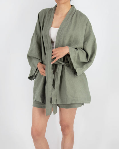 Person wearing a green robe on a white background