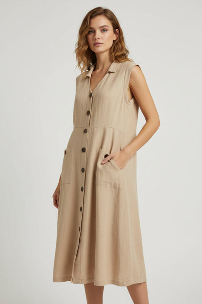 Beige sleeveless dress with buttons on a mannequin against a blue background