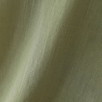 A close-up of a textured fabric in a muted sage green color, showing the weave and soft folds.