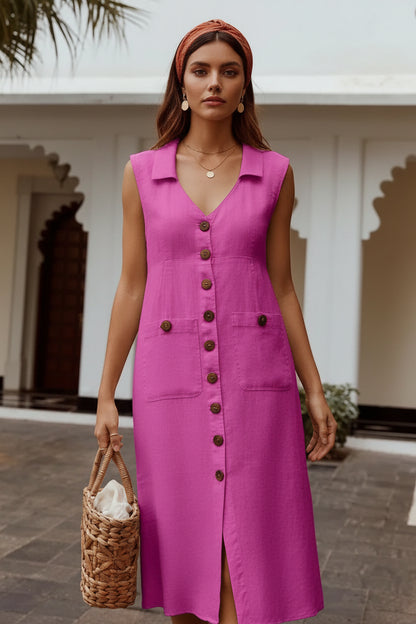 Woman wearing a pink denim dress with buttons, standing outdoors.