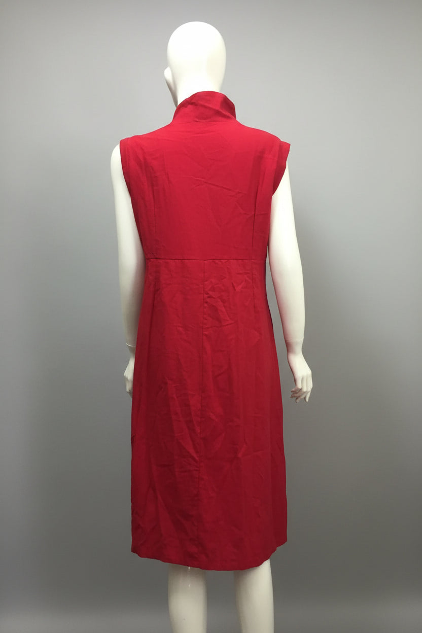 Red sleeveless dress on a mannequin against a blue wall