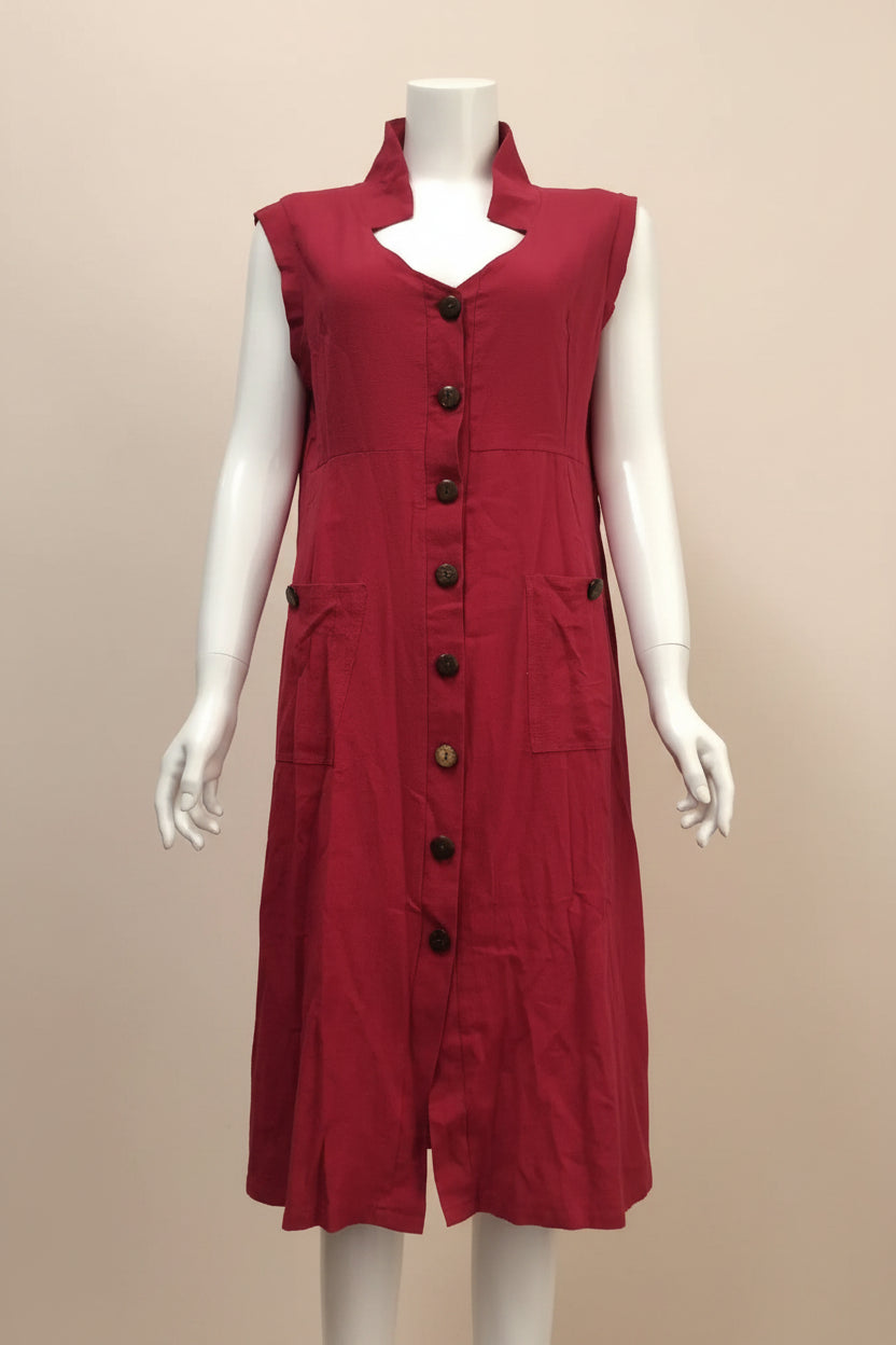 Red dress on a mannequin against a blue wall with storage shelves in the background