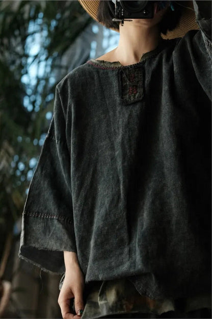 Person wearing a dark green outfit with a blurred natural background