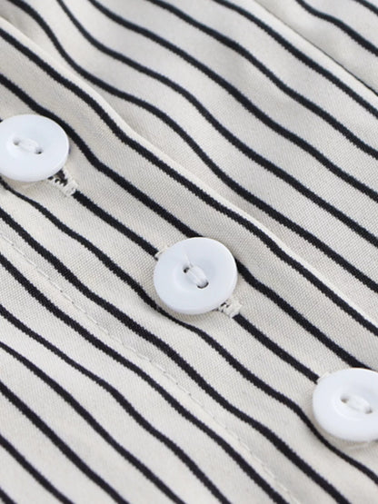 Close-up of a striped fabric with white buttons on a black and white striped background