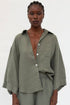 Woman wearing a green outfit against a white background