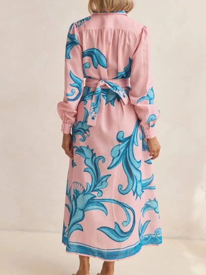 Woman wearing a pink robe with blue floral patterns on a beige background