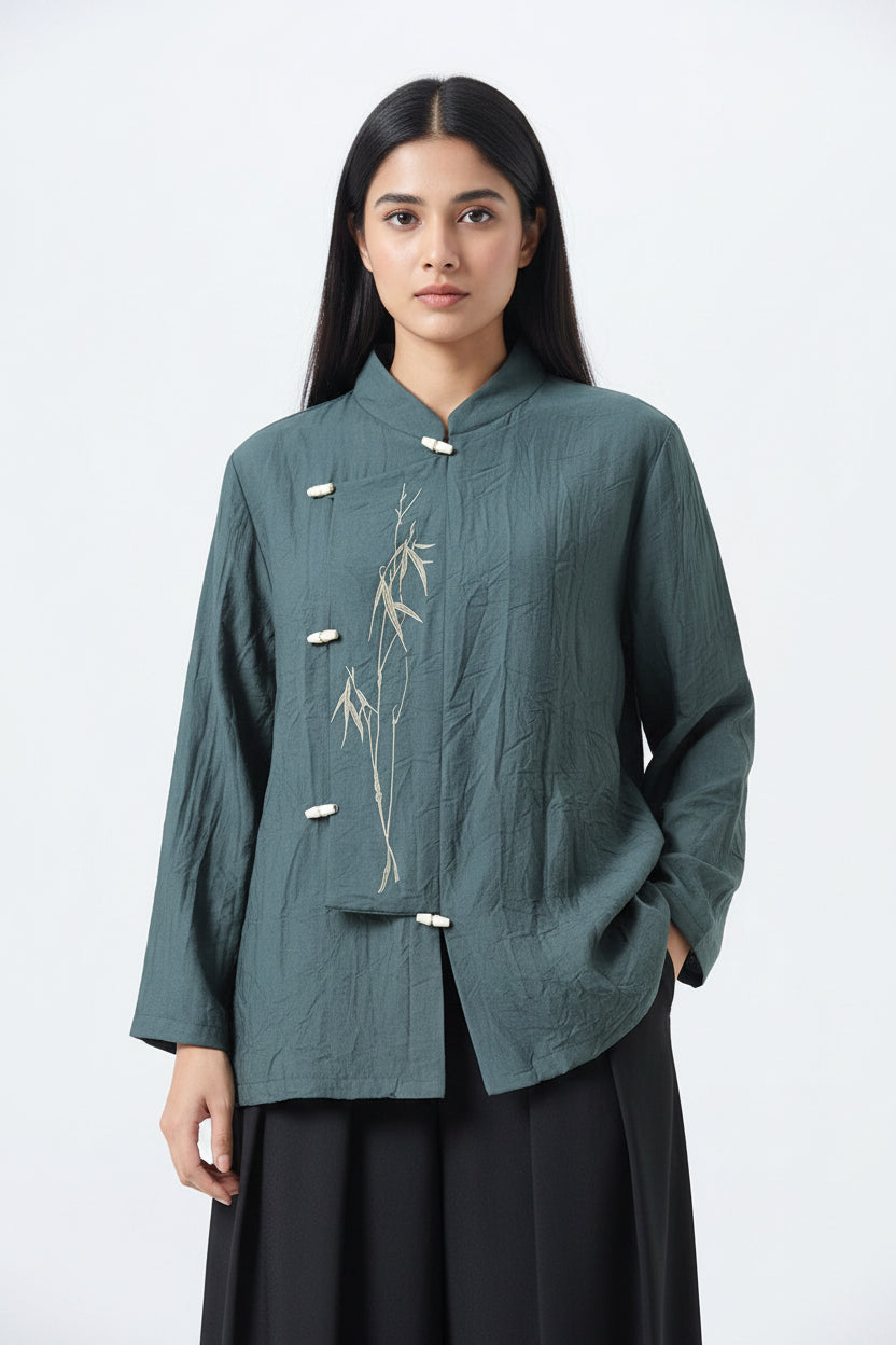 Teal traditional jacket with bamboo embroidery on a plain background