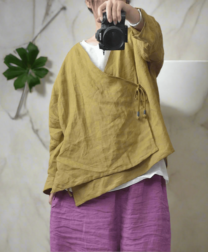 Woman wearing yellow  ramie v-neck boho blouse.