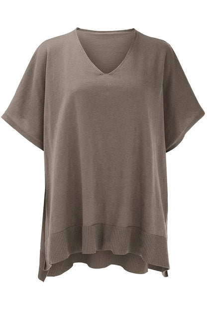 Brown knit poncho on a white background