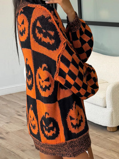 Person wearing an orange and black sweater with pumpkin patterns indoors.