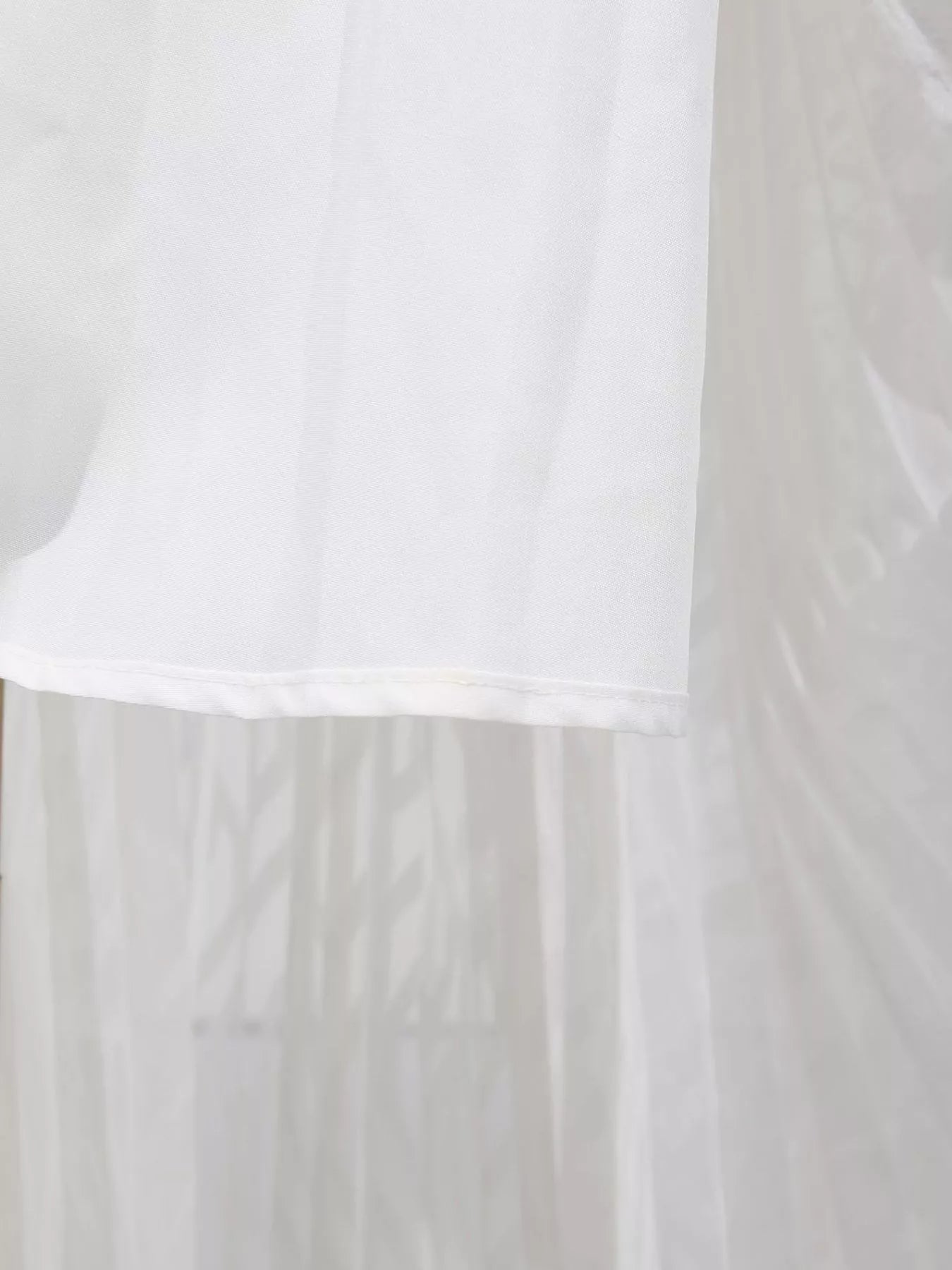 White fabric with a subtle pattern on a plain background