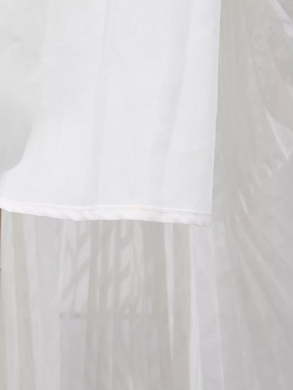 White fabric with a subtle pattern on a plain background