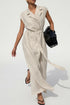 Person wearing a white dress crossing a street with cars and buildings in the background