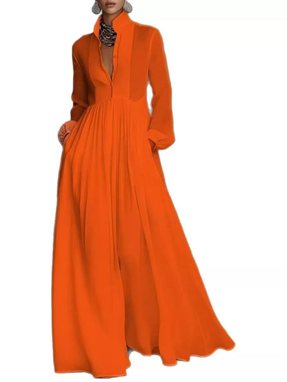 A_model_posing_in_a_vibrant_orange_long-sleeve_button-front_maxi_dress_featuring_a_V-neckline_Victorian-inspired_sleeves_and_a_relaxed_flowy_silhouette