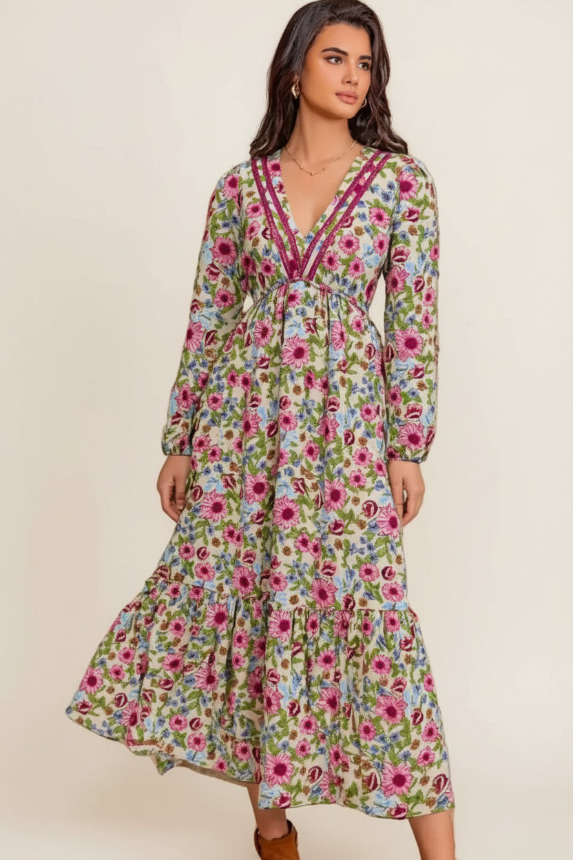 Woman wearing a floral dress against a beige wall