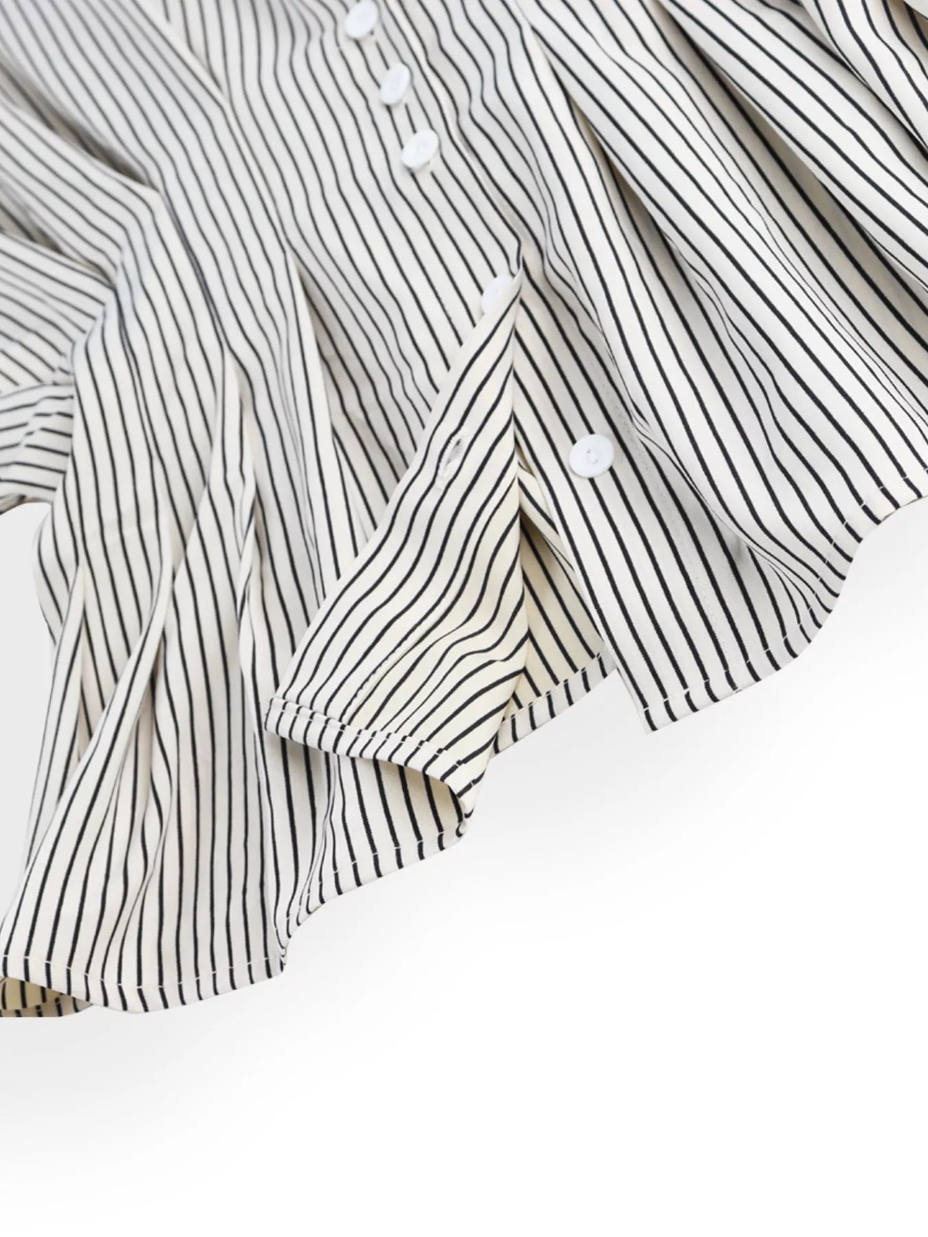 Close-up of a black and white striped shirt with buttons on a white background